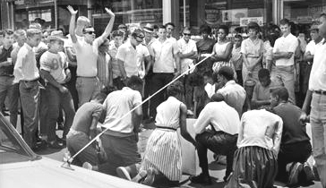 NEWS FILE/ANTHONY FALLETTA June 15, 1963 Protests in Birmingham spread to other cities including Gadsden where these demonstrators gather on a sidewalk under the taunts of whites. The protests in Gadsden were not widely reported in Birmingham. Earlier the same week Gov. George Wallace came out against Vivian Malone's enrollment at the University of Alabama.